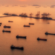 Aerial view Oil ship tanker park on the sea at dusk for transportation crude oil from refinery